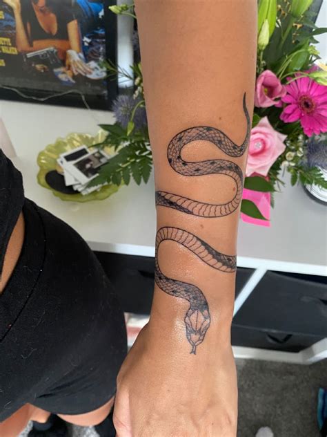 snake around arm tattoo meaning|snake tattoo on wrist meaning.